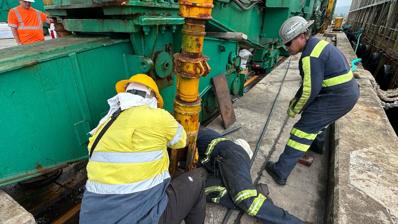 RECOVERY: Port Authority of Guam employees and Smithbridge personnel work to return a wheel on Gantry Crane 5 to the rail system Sunday, October 4, 2026, as crane recovery efforts continue following Friday night’s high wind incident. Caption and Photo Courtesy of Port Authority of Guam.