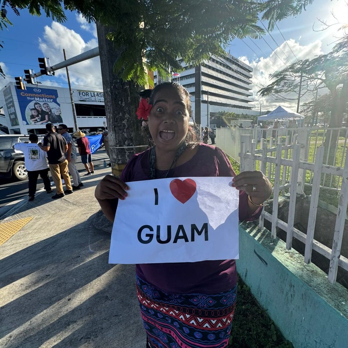 Protesters gather with signs directed at attorney general